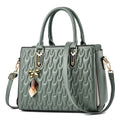 Women's polyester shoulder messenger bag with a front PU pocket in green, showing its structured shape and strap.