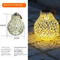 Outdoor solar lantern light with imitation bamboo weaving pattern, hanging in garden setting