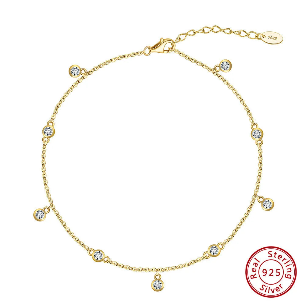 Women's silver geometric anklet with a small zirconium pendant, shown in gold and white gold colour options.