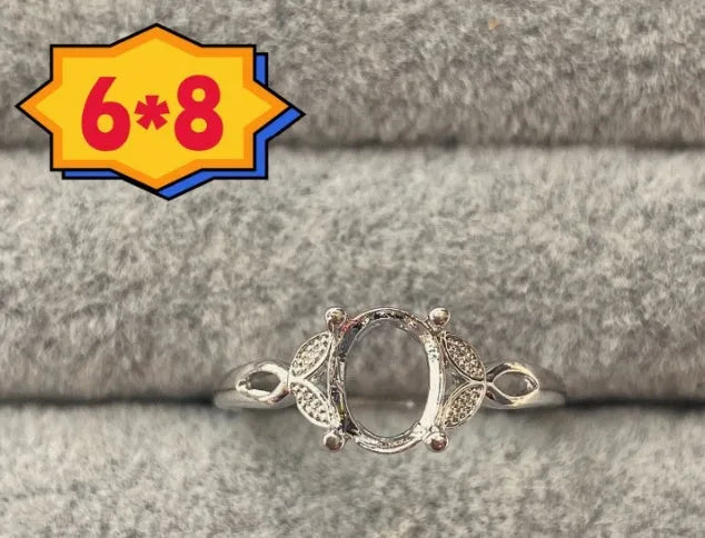 Oval open mouth copper ring with a 6*8 centre stone and five-pointed star ornament detail.