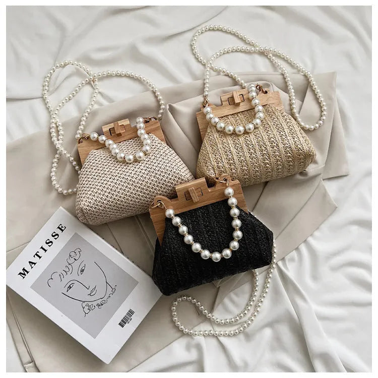 Women's straw shoulder bag with woven pearl chain detail and multiple internal compartments