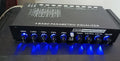 Car audio equaliser with front panel controls showing frequency bands and volume adjustments
