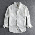 Men's light blue cotton long sleeve shirt in a retro cardigan style on a hanger