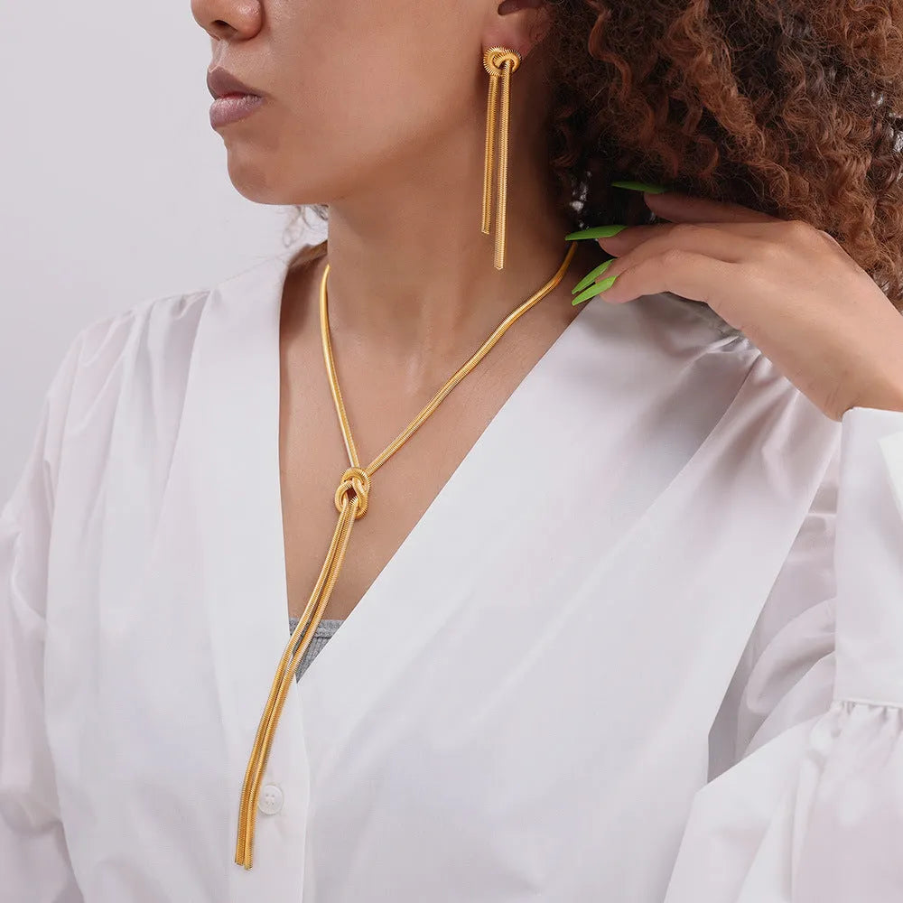 Gold electroplated titanium steel necklace with knotted tassel pendant and matching earrings set