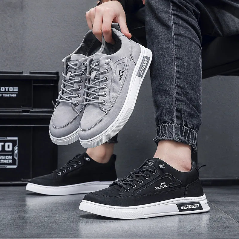Grey men's low-top canvas casual sneakers with lace-up front and round toe on a rubber sole.
