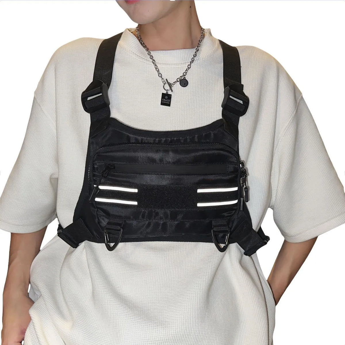 Black nylon tactical chest bag with reflective tooling style, solid colour, polyester lining and sewing thread detail
