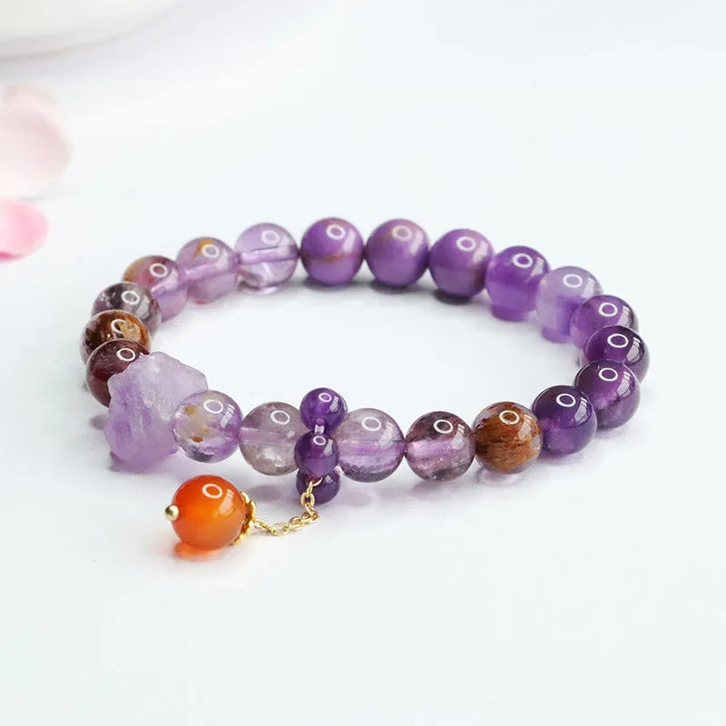 Natural Nine Purple Amethyst and red agate Mori style bracelet on wrist.