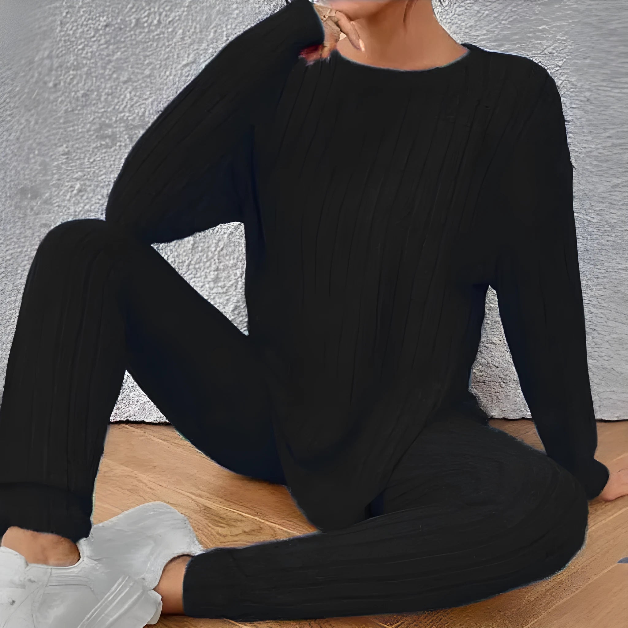Black sunken stripe pattern two-piece loungewear set with regular sleeves on a hanger.