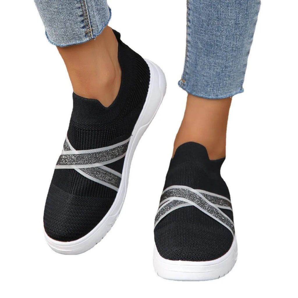 Black women's low-top casual shoes with Flyknit mesh fabric and a flat rubber sole.