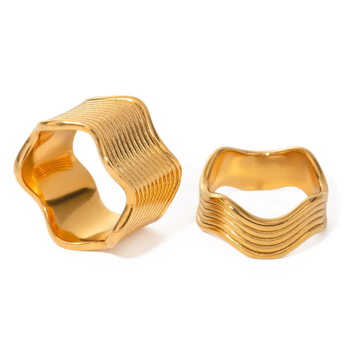 Stainless steel women's ring with wide geometric wave design in silver or rose gold tone.