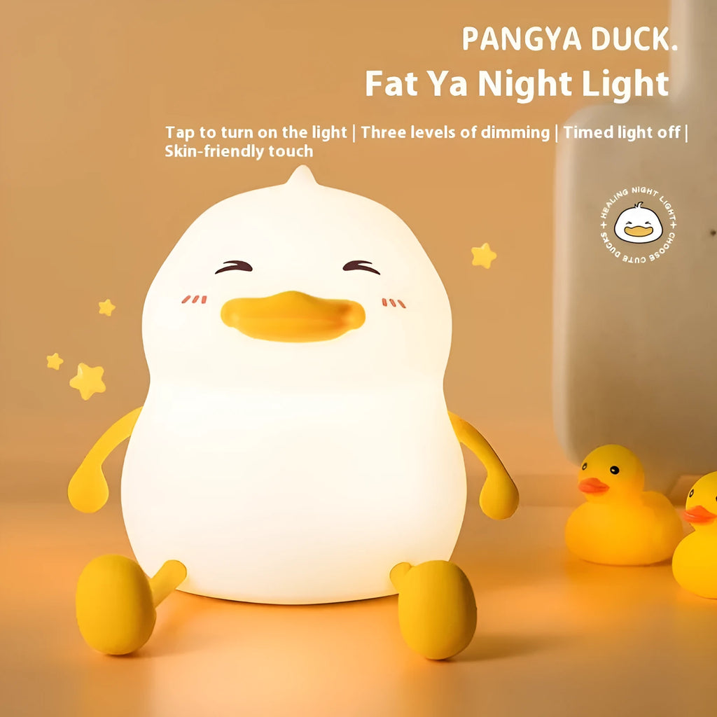 Chubby silicone rechargeable night light on a desk, showing soft glow and touch-sensitive surface.