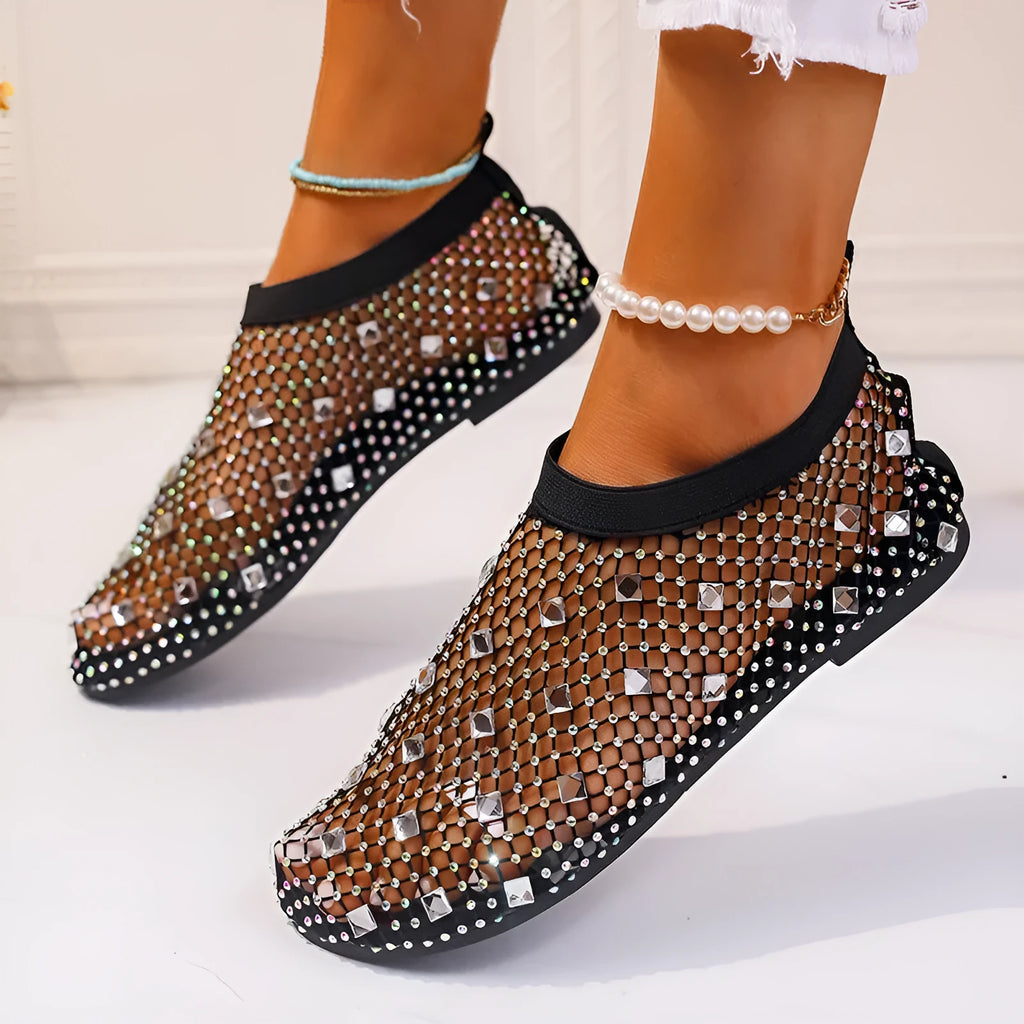 Colourful rhinestone detail on women's white mesh flat sandals with a round toe and rubber sole.