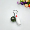 Mini simulation bowling ball keychain pendant in dark red, blue, purple, and green colour options.