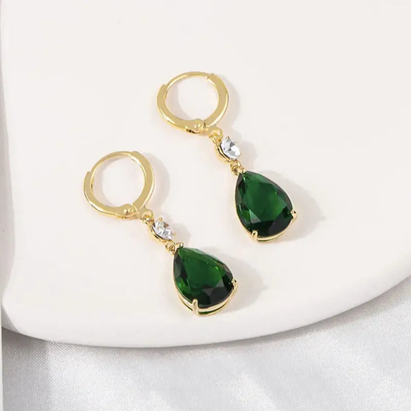 A pair of green geometric teardrop alloy earrings on a white background.