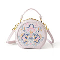 National style round crossbody bag in khaki PU leather with embroidery and sewing line details, shown on a plain background