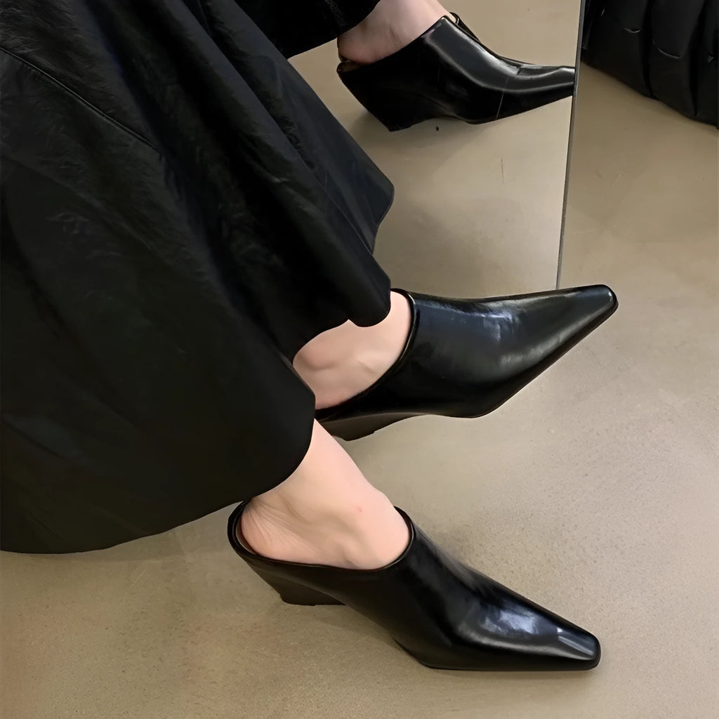 Women's black wind wedge style half slippers with closed toe, made from PU material.