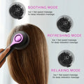 Black USB-powered head massage comb with vibration settings on a grey background.