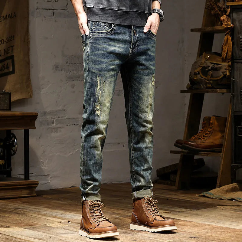 Men's slim-fit jeans in a retro colour with a zip fly, shown laid flat.