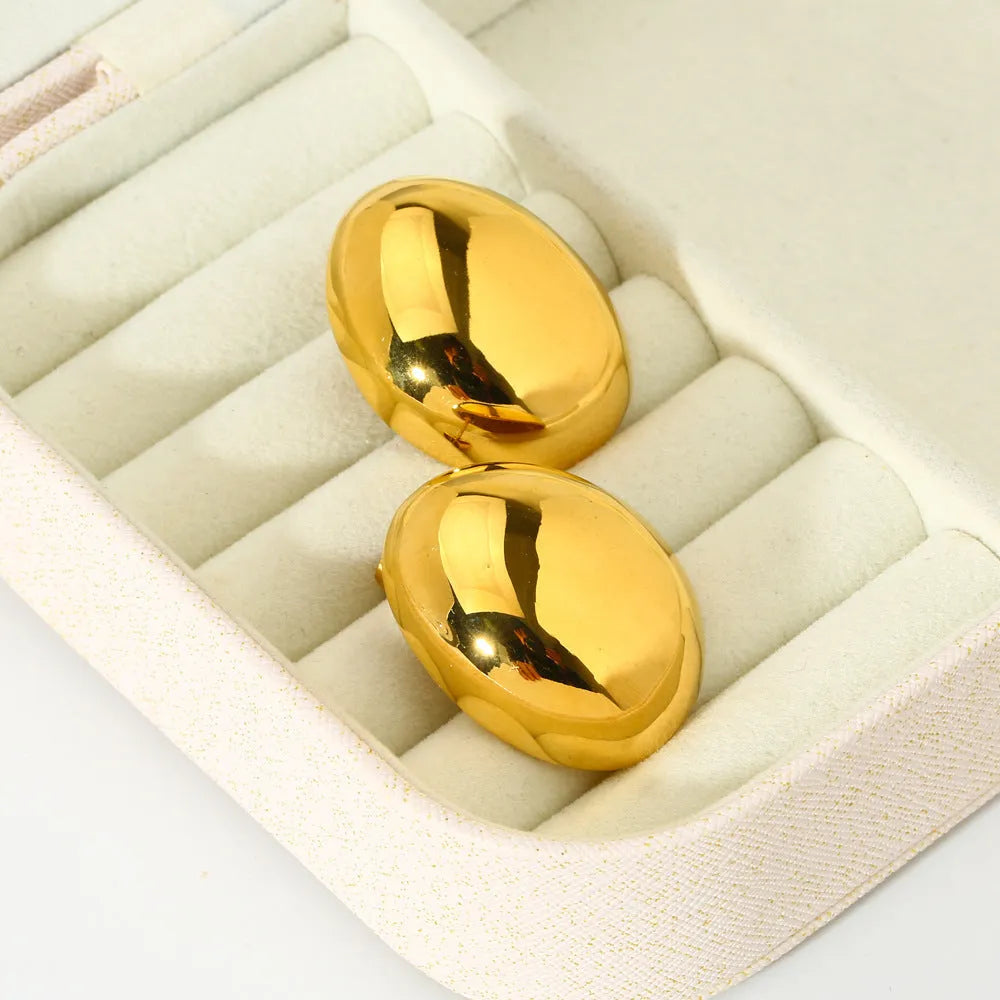 A pair of geometric stainless steel ear studs with an 18K gold plated, glazed surface and line detailing.