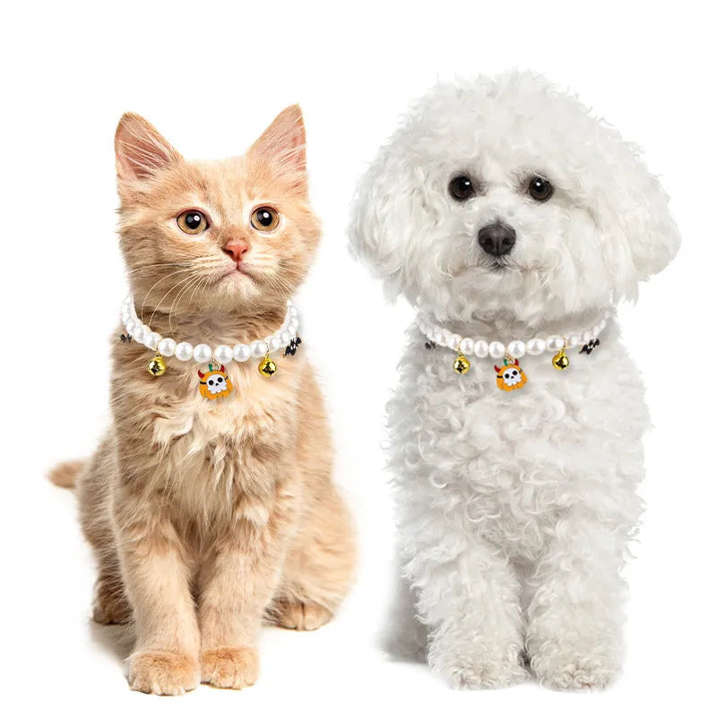 Three pearl and bell necklaces for pets laid out, suitable for cats and small dogs.