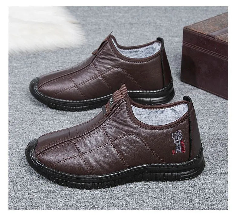 Men's brown winter cotton boots with a buckle closure and a thick, treaded non-slip sole.
