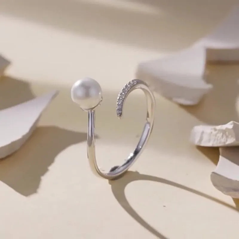 S925 sterling silver adjustable ring with natural shell pearl centrepiece showing open loop design