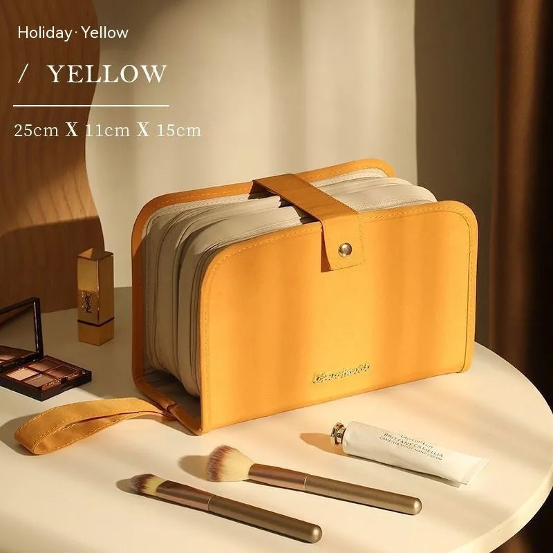 Large capacity leather book cosmetic bag in sunset yellow, open to show interior, with imitation leather finish.