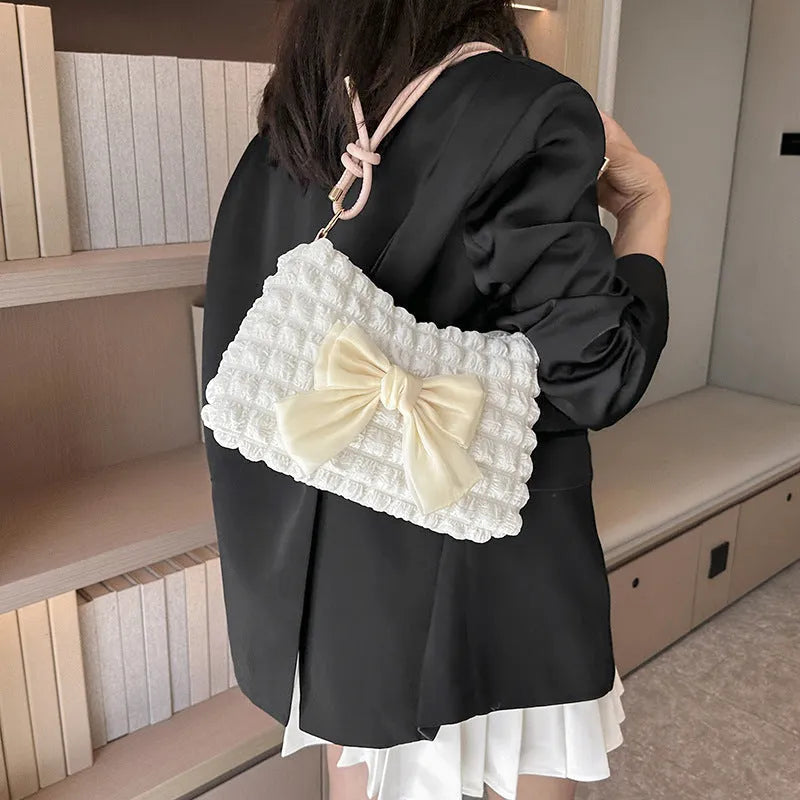 Women's black canvas one-shoulder handbag with a single strap and visible sewing thread detail