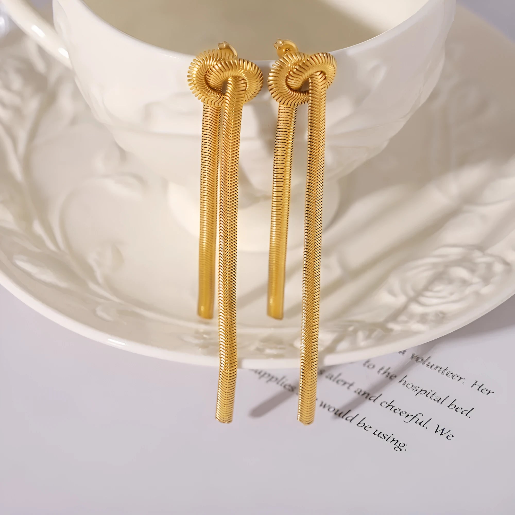 Gold electroplated titanium steel necklace with knotted tassel pendant and matching earrings set