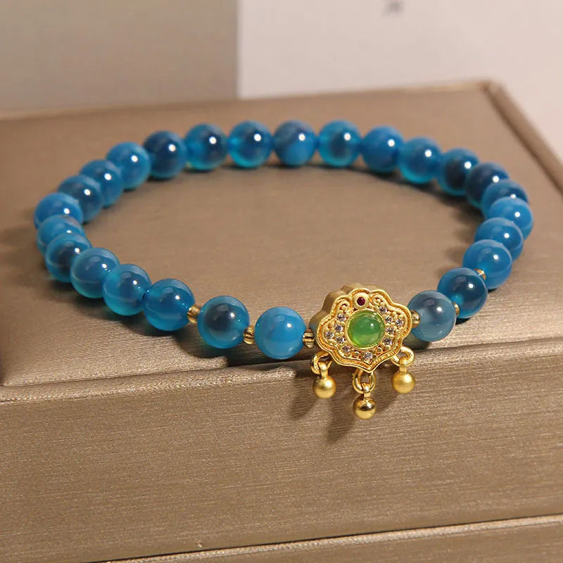 Women's blue sugar heart agate safety lock pendant bracelet with crystal and rhinestone details on alloy.