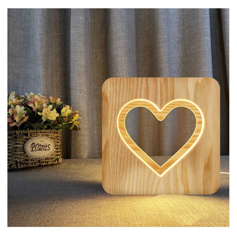 Solid wood hollow LED night lamp warm white with USB cable on wooden surface