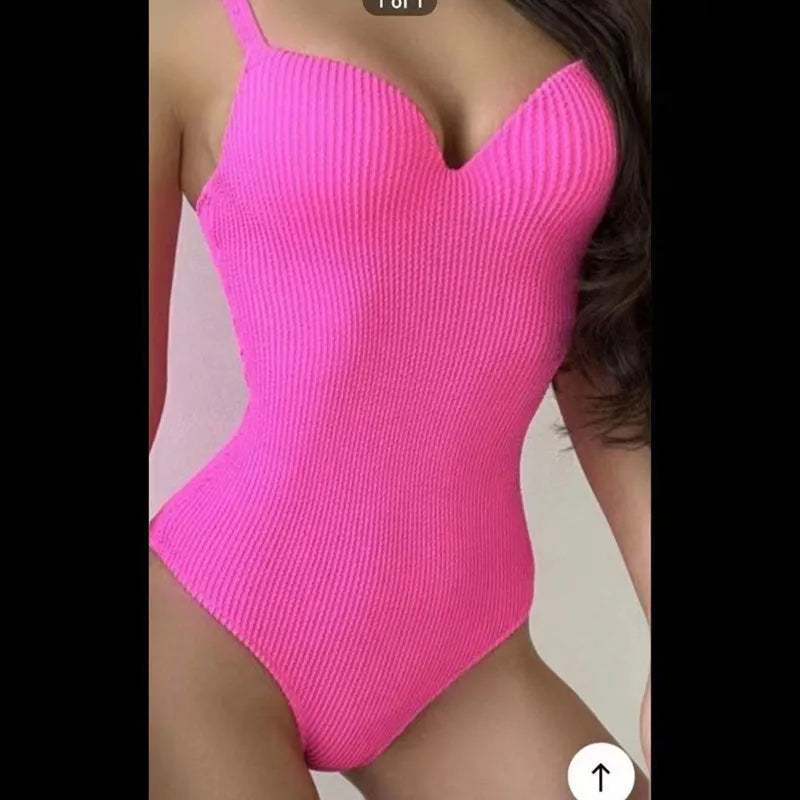 Women's black sleeveless one-piece swimsuit with a sunken stripe pattern on the front.