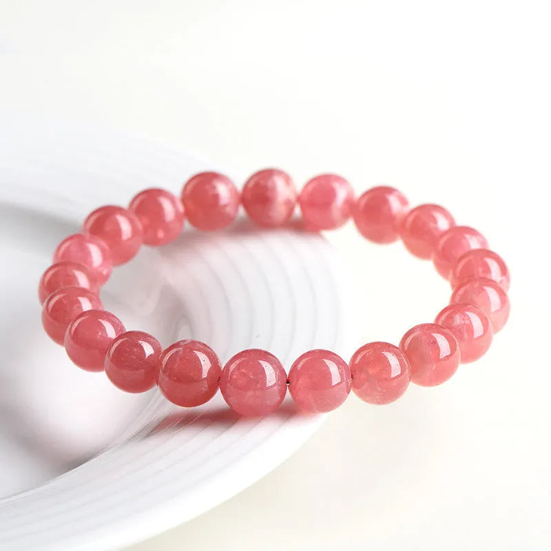 Women's geometric crystal bracelet with a longevity lock clasp in natural red rhodochrosite stone.