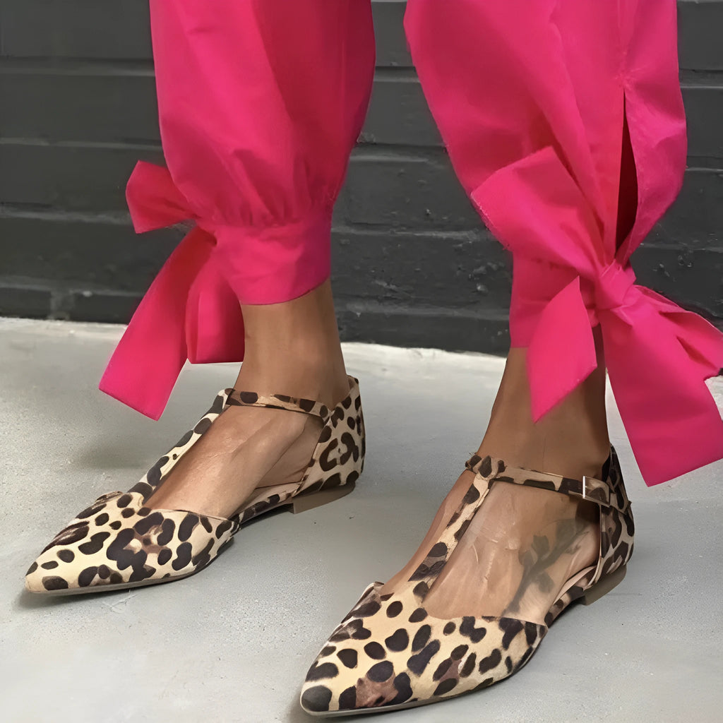 Leopard print women's pumps with pointed toe, chunky low heel, and ankle strap
