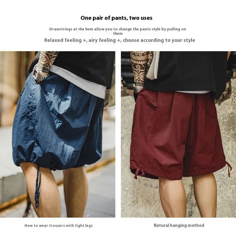 Prussian blue men's nylon loose beach shorts with embroidery on knee-length leg.