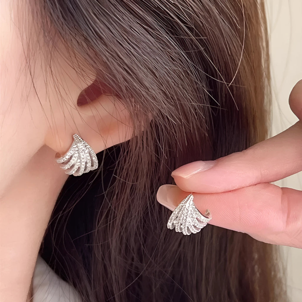 A pair of geometric-shaped earrings with a line design, made from zircon with an electroplated platinum finish.