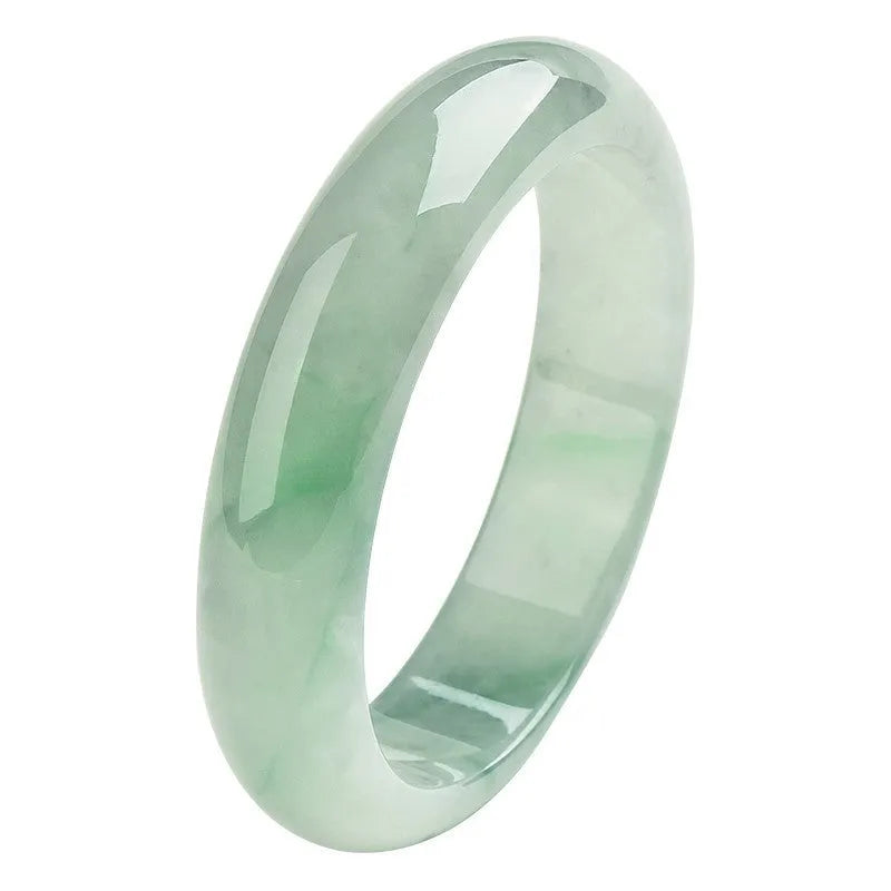 Light green jade bracelet on wrist, natural style, showing sizing scale from 53mm to 64mm