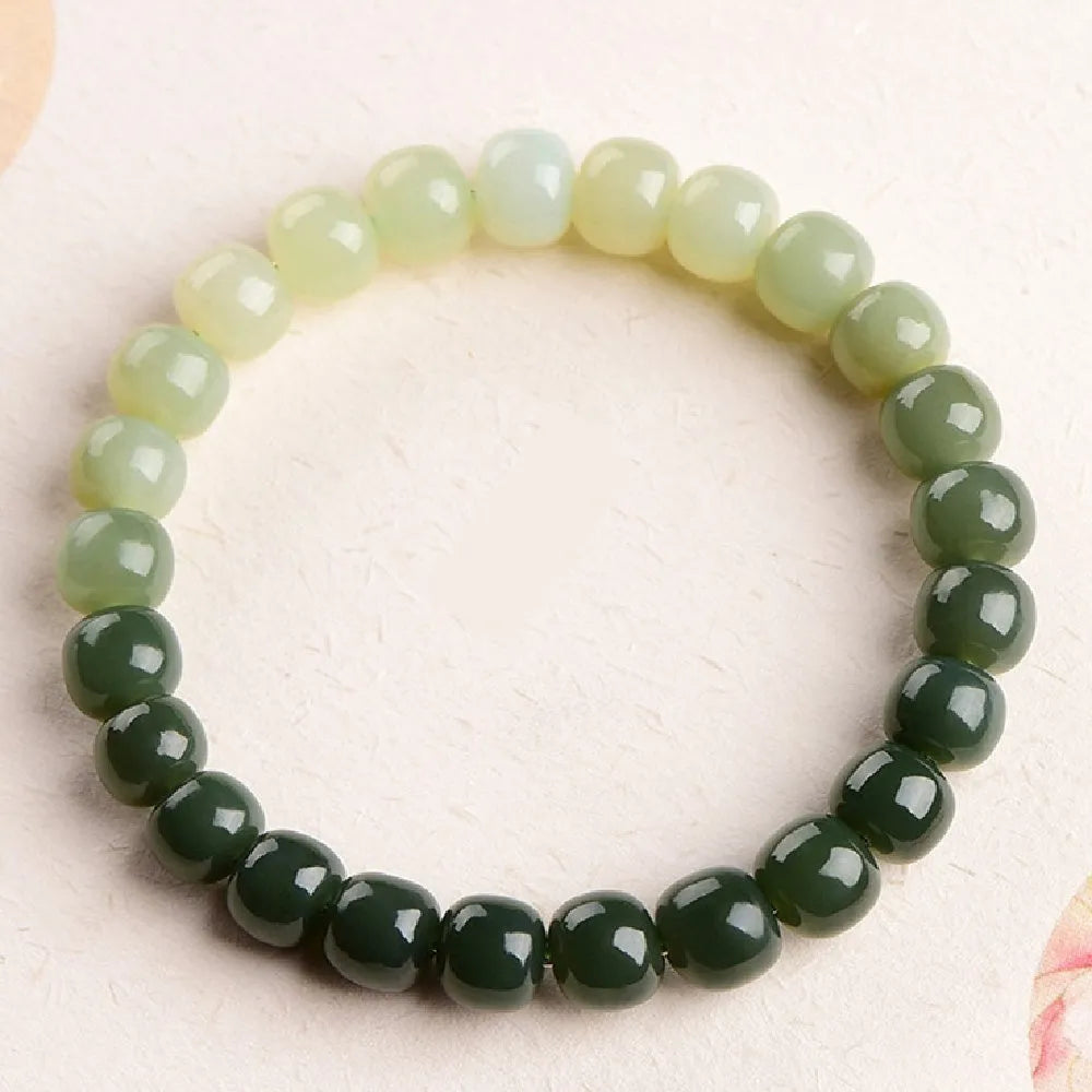 Polished Hetian Jade bracelet showing a gradient water colour on beads.