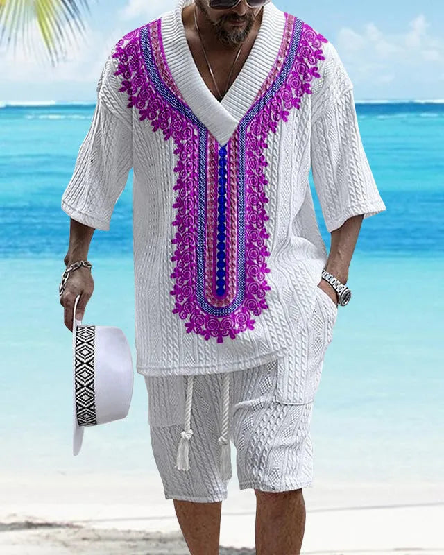 Man wearing a printed drop-shoulder knitted short-sleeved top with matching shorts in a solid colour.