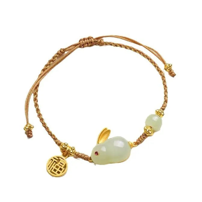 Hetian jade geometric rabbit charm bracelet on a yellow string for women.