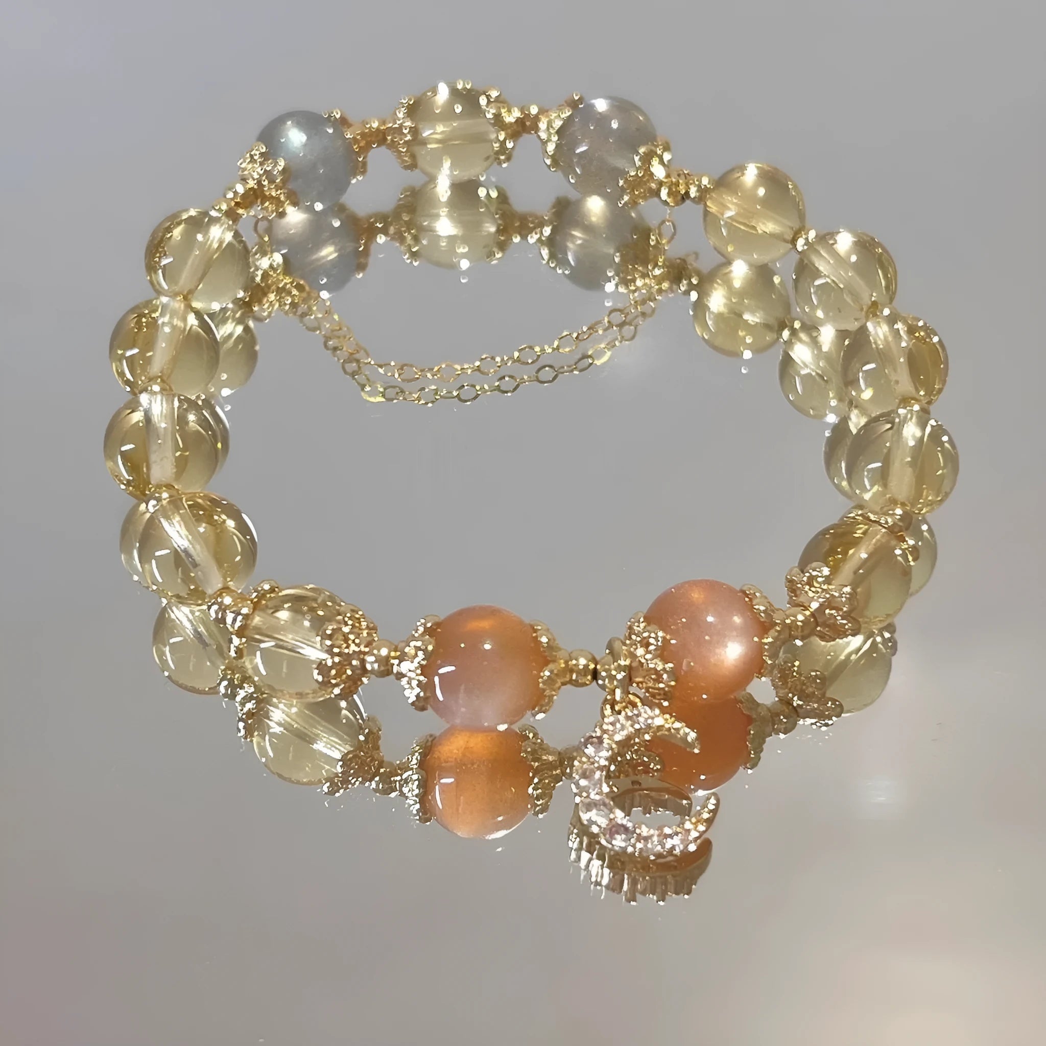 Moonstone crystal bracelet with 14K gold electroplating and diamond-shaped citrine beads on adjustable band