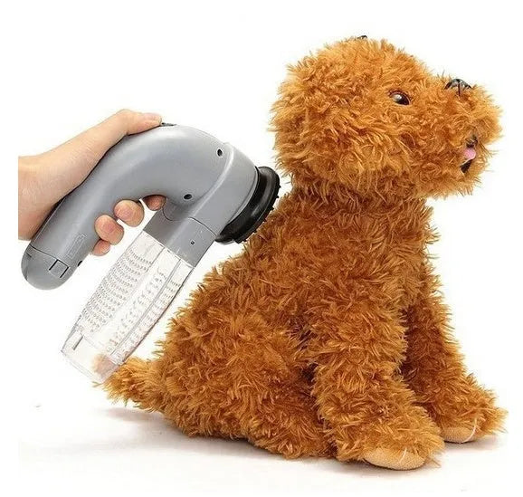 Grey handheld electric pet hair remover vacuum brush with soft rubber head.