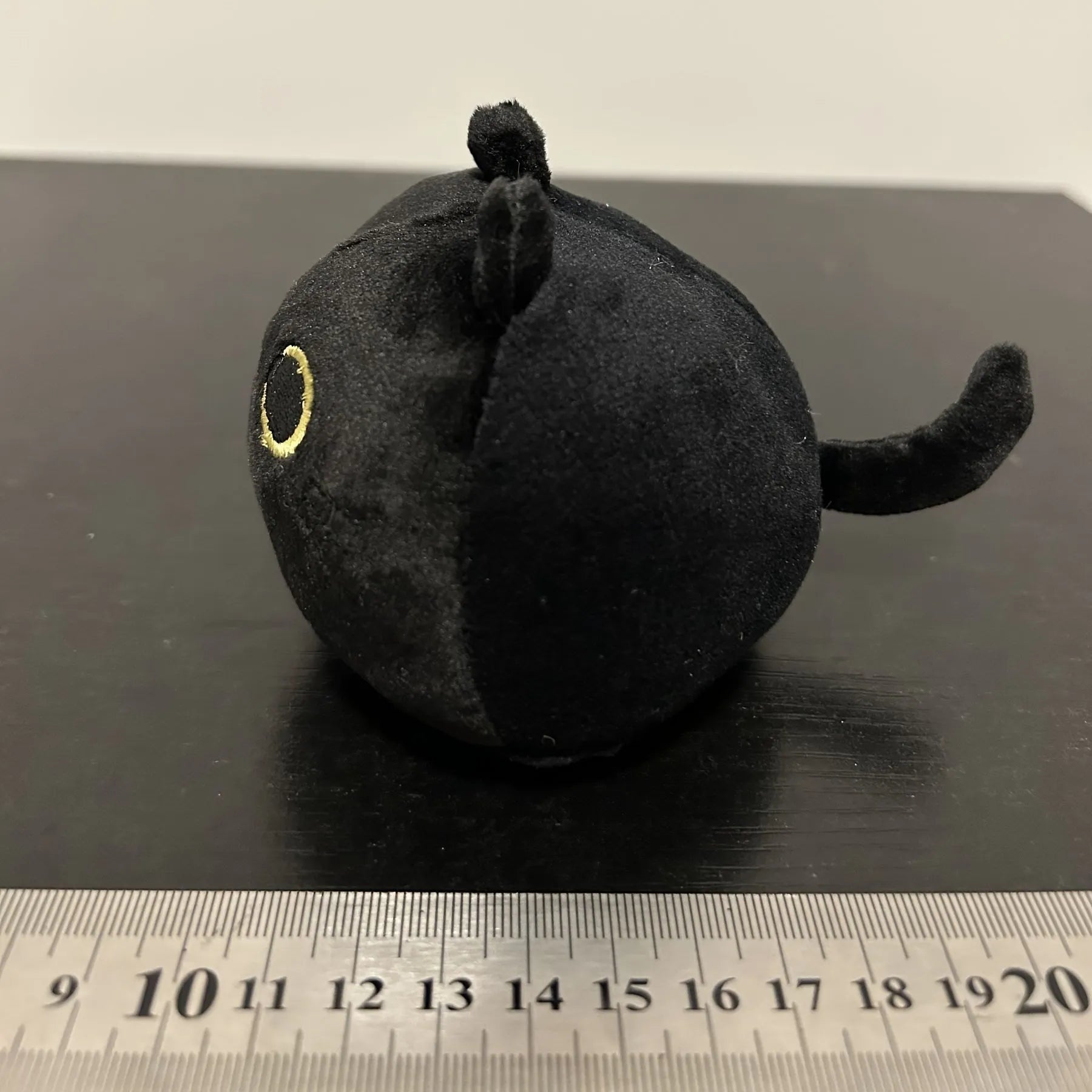 Black fluffy cat plush toy stuffed animal shown as a soft pillow cushion approximately 35cm long.