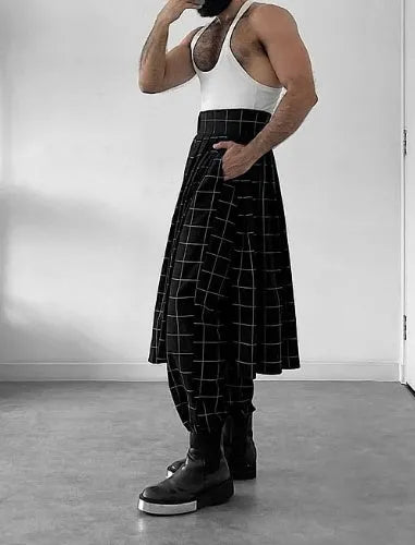 Man wearing plaid trousers with apron detailing, showing drawstring waist and multiple pockets.