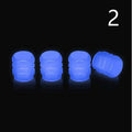 Set of luminous green and blue rubber tyre valve caps on a tyre valve stem.