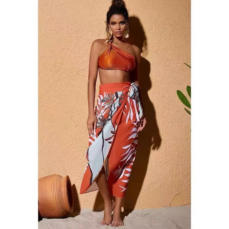 Women's brown push-up high-waist bikini with a matching chiffon skirt cover-up laid flat.