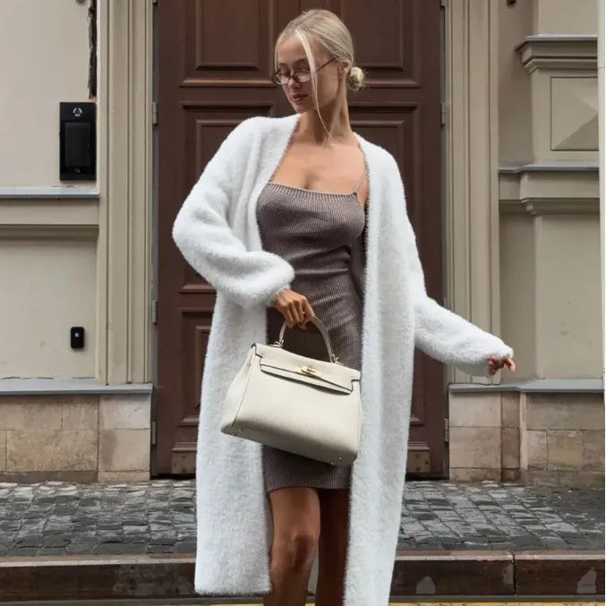 White longline knitted cardigan jacket with long sleeves on a hanger