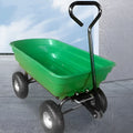 Green TC2145 four-wheel toy dump truck with steel frame and plastic body in a garden setting.