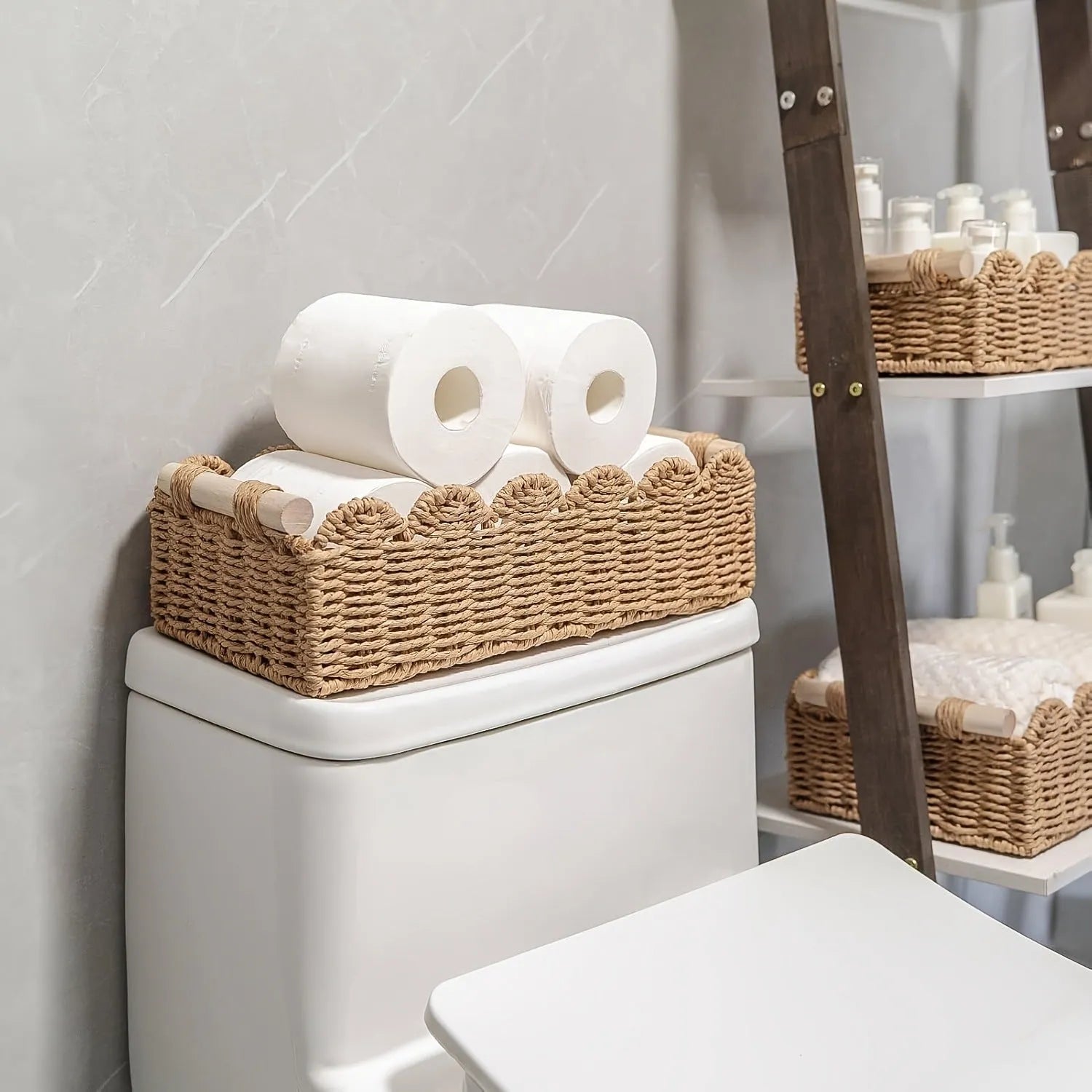 Woven paper storage basket in khaki colour on a desktop holding remote controls and pens.