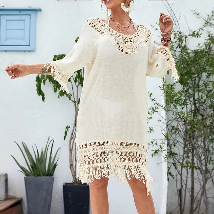 Apricot-coloured women's crocheted patchwork beach dress with half sleeves on a hanger.